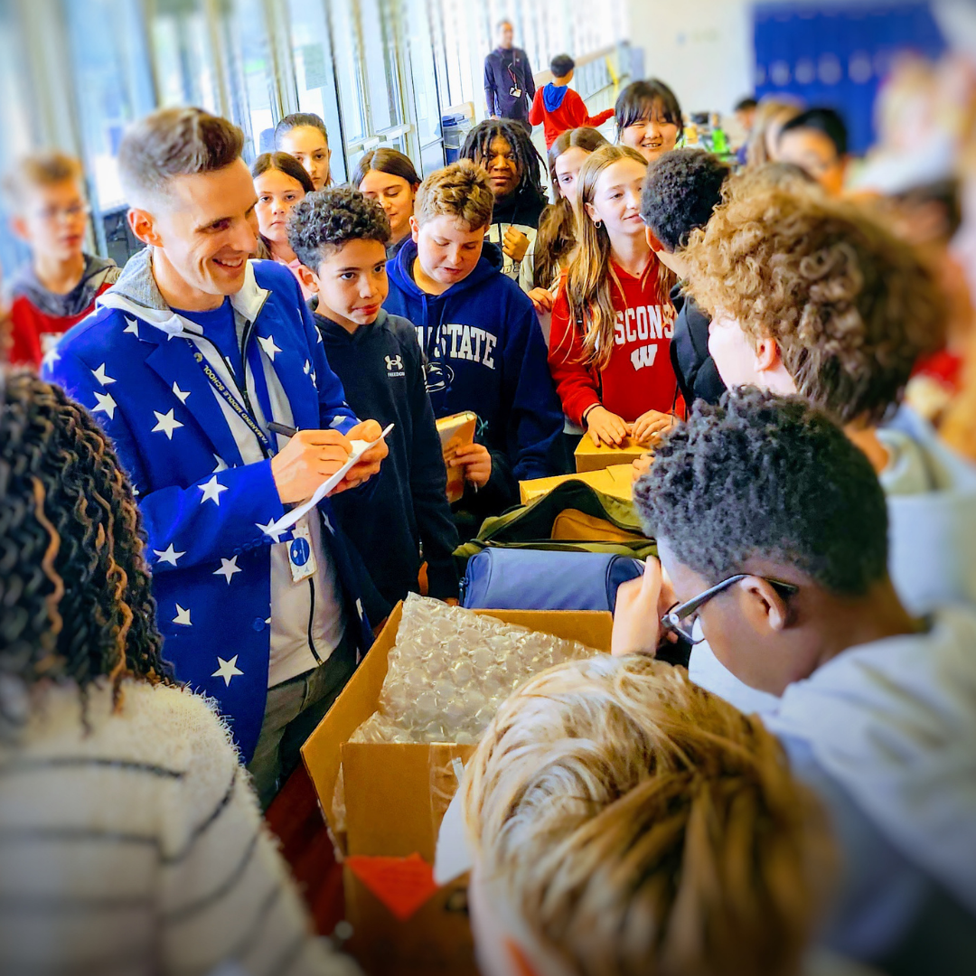 Matthew Landis signing books for students